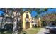 Condo building with multiple units, balconies, and ample parking at 713 Crest Pines Dr # 236, Orlando, FL 32828