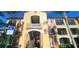 Condo building showcasing stairs, accessible parking, and landscaping at 713 Crest Pines Dr # 236, Orlando, FL 32828