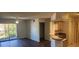 Spacious living room with wood-look floors and access to a balcony at 713 Crest Pines Dr # 236, Orlando, FL 32828