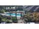 Inviting community pool area with pergola and ample seating at 713 Crest Pines Dr # 236, Orlando, FL 32828