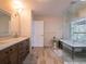 Spa-like bathroom featuring a double vanity, walk-in shower, and soaking tub at 1400 S Pennsylvania Ave, Winter Park, FL 32789