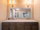 Double vanity bathroom with a large mirror and modern lighting at 1400 S Pennsylvania Ave, Winter Park, FL 32789