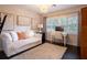 Bright bedroom with a comfortable sitting area and home office at 1400 S Pennsylvania Ave, Winter Park, FL 32789