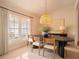 Bright dining room with an oval table, large window, and neutral decor at 1400 S Pennsylvania Ave, Winter Park, FL 32789
