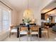 Modern dining room features an oval table, rattan light, and neutral decor at 1400 S Pennsylvania Ave, Winter Park, FL 32789
