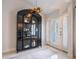 Bright entryway with a large, black curio cabinet and white door at 1400 S Pennsylvania Ave, Winter Park, FL 32789