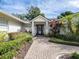 Front entry of a home with a brick walkway and manicured landscaping at 1400 S Pennsylvania Ave, Winter Park, FL 32789