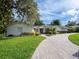 Single-story house with a paver driveway and lush landscaping at 1400 S Pennsylvania Ave, Winter Park, FL 32789