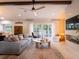 Cozy living room with a gray couch, round coffee table, and sliding glass doors at 1400 S Pennsylvania Ave, Winter Park, FL 32789