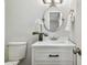 Small bathroom with white vanity, oval mirror, and updated fixtures at 2227 Miguel St, Lakeland, FL 33801