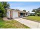 Brick home with a white garage door and a walkway leading to the porch at 2227 Miguel St, Lakeland, FL 33801