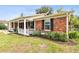 Brick ranch house with a covered porch and well-maintained landscaping at 2227 Miguel St, Lakeland, FL 33801