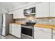 Updated kitchen with stainless steel appliances and wood countertops at 2227 Miguel St, Lakeland, FL 33801