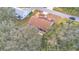 House with backyard patio and surrounding trees at 4064 River Crest Cir, Leesburg, FL 34748