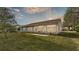 The back of the house has a patio with chairs in the green lawn with a screened-in lanai at 4064 River Crest Cir, Leesburg, FL 34748
