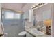 Bathroom featuring a toilet, shower with sliding door, sink with vanity, and medicine cabinet at 4064 River Crest Cir, Leesburg, FL 34748