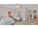 Bedroom features two twin beds, carpet and a sliding door closet, offering a cozy and functional space at 4064 River Crest Cir, Leesburg, FL 34748