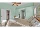 A spacious bedroom featuring a ceiling fan and ensuite bathroom access at 4064 River Crest Cir, Leesburg, FL 34748