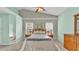 Bright bedroom with vaulted ceilings, matching nightstands, and a ceiling fan at 4064 River Crest Cir, Leesburg, FL 34748