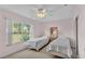 Bedroom with two twin beds and a large window at 4064 River Crest Cir, Leesburg, FL 34748