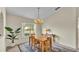 Cozy dining area with a chandelier, wood table and chairs, and access to the kitchen at 4064 River Crest Cir, Leesburg, FL 34748