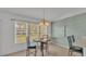 Dining room features a table set for four with large windows allowing natural light at 4064 River Crest Cir, Leesburg, FL 34748