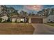 Charming single-story home with well-maintained lawn, mature trees, and inviting curb appeal at 4064 River Crest Cir, Leesburg, FL 34748