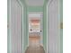 Hallway leads to a bright bathroom featuring a soaking tub and soft lighting at 4064 River Crest Cir, Leesburg, FL 34748