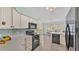 Kitchen with island, black appliances, and lots of cabinet space at 4064 River Crest Cir, Leesburg, FL 34748