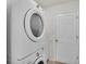 Modern laundry room with white stacked washer and dryer set at 4064 River Crest Cir, Leesburg, FL 34748