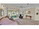 Bright living room with large sliding doors opening to an enclosed lanai at 4064 River Crest Cir, Leesburg, FL 34748