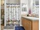 Clean bathroom with shower/tub combo and wood cabinets at 555 Lindsey Dr, Lakeland, FL 33809