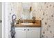Small bathroom with vanity and floral wallpaper at 555 Lindsey Dr, Lakeland, FL 33809
