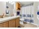 Bathroom with shower/tub combo and wood cabinets at 555 Lindsey Dr, Lakeland, FL 33809