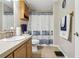 Bathroom with shower/tub combo and wood cabinets at 555 Lindsey Dr, Lakeland, FL 33809