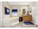 Bathroom with corner bathtub and wood cabinets at 555 Lindsey Dr, Lakeland, FL 33809
