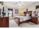 King bedroom with wood furniture and large windows at 555 Lindsey Dr, Lakeland, FL 33809