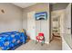 Bright bedroom with twin bed, red chair, and access to bathroom at 555 Lindsey Dr, Lakeland, FL 33809