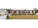Single-story manufactured home with carport and landscaped yard at 555 Lindsey Dr, Lakeland, FL 33809