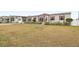 Landscaped yard with tan manufactured home and red trim at 555 Lindsey Dr, Lakeland, FL 33809