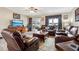 Living room with leather furniture, wood-look floors, and a view of the back patio at 555 Lindsey Dr, Lakeland, FL 33809