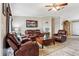 Living room with leather furniture, wood-look floors, and access to the kitchen at 555 Lindsey Dr, Lakeland, FL 33809