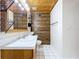 Bathroom with wood-paneled walls, a white vanity, and a toilet at 6205 Indian Ln, Lakeland, FL 33813