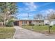 Charming brick ranch home with a spacious lawn and driveway at 942 Hanover Ave, Winter Park, FL 32789