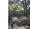 Landscaped backyard with a walkway leading to a wooden gate at 190 Post Way, Casselberry, FL 32707