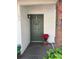 Inviting front entrance with green door, welcome wreath, and charming decor creates a warm, welcoming feel at 190 Post Way, Casselberry, FL 32707