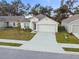 Single-story home with two-car garage and landscaped yard at 1976 Thompson Preserve Blvd, Bartow, FL 33830