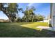 Backyard with large trees and grassy area at 1976 Thompson Preserve Blvd, Bartow, FL 33830