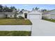 Newly built home with a two-car garage and well-manicured lawn at 1976 Thompson Preserve Blvd, Bartow, FL 33830