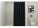 Clean bathroom with a shower/tub combo and dark gray shower curtain at 1294 Deepwater Cir, Eagle Lake, FL 33839